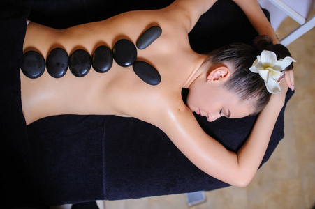 一位女性顾客在美容spa侧视下的结石治疗