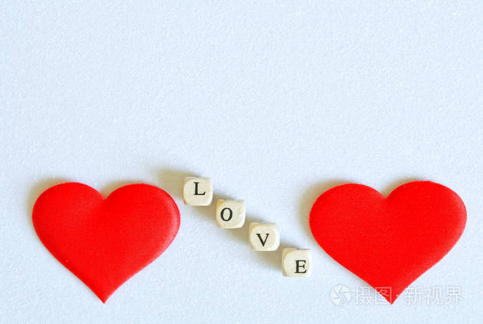 两颗红绸心和一颗白色的闪闪发光的铭文爱