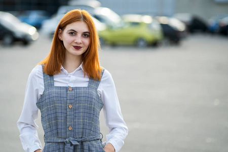 Portrait of a smiling teenage girl with red hair and clear eyes 