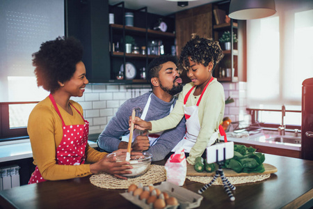 快乐的黑人家庭在厨房度过一天。