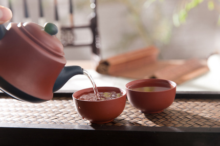 古代茶拿着茶壶倒茶照片