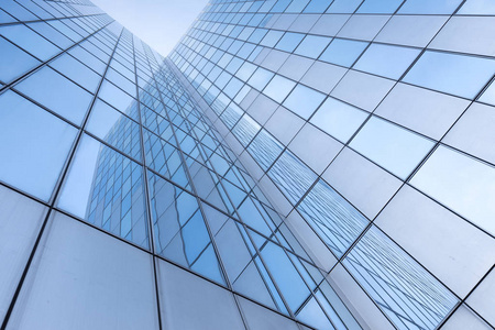 glass facades of modern  buildings and reflection of blue 
