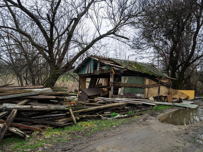 被遗弃和掠夺的房子.垃圾堆中间的破木屋照片