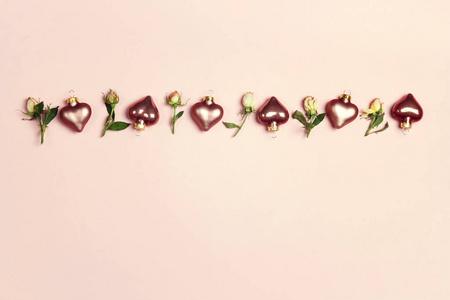 Decorative hearts and little roses on a pink background. 