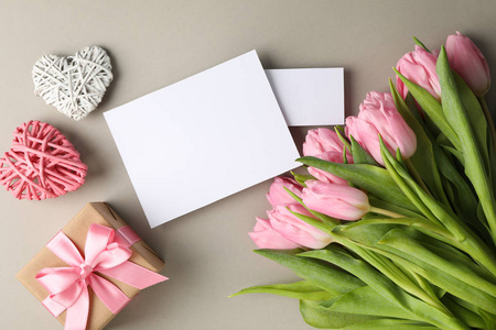 Tulips, gift, hearts and empty places on grey background, space 