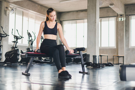 Beautiful girl caucasian is exercising with lifting dumbbell in 