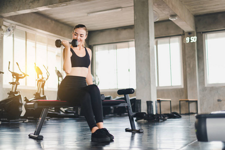 Beautiful girl caucasian is exercising with lifting dumbbell in 