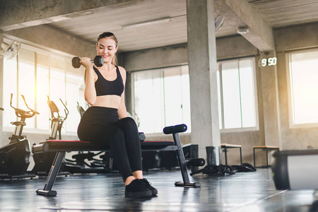 Beautiful girl caucasian is exercising with lifting dumbbell in 