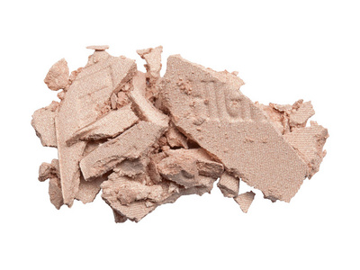 Sample of dry crushed highlight face powder isolated on white 