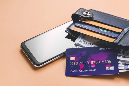 彩色背景上有信用卡和手机的钱包