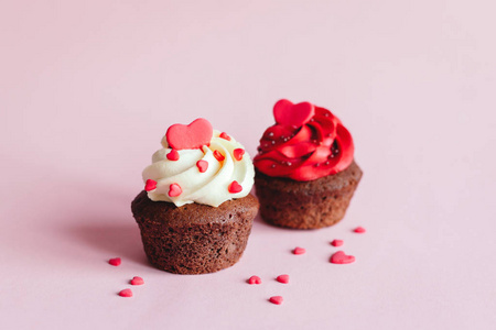 Valentine cupcakes, decorated with sweet hearts on pink pastel b