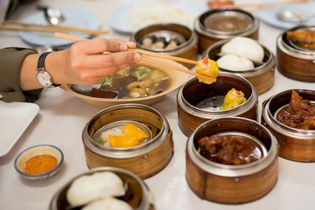 餐厅里手拿筷子夹着饺子点心。