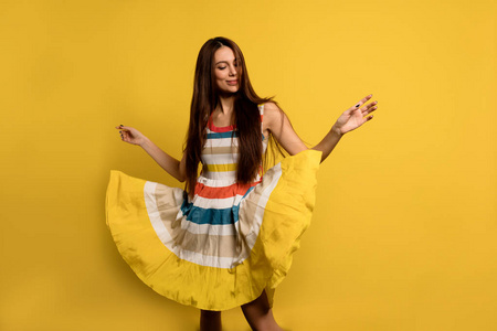 Charming pretty lady with long dark hair wearing summer stripped