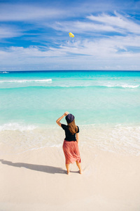 girl in a hat on a background of the ocean. Beautiful girl looks