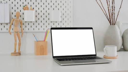 Cropped shot of modern designer workspace with mock up laptop, w