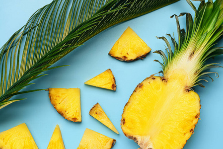 鲜切菠萝和棕榈叶的彩色背景