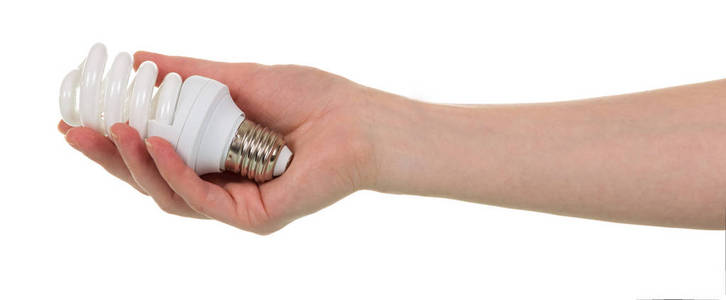 In female hand fluorescent light bulb is isolated on white 