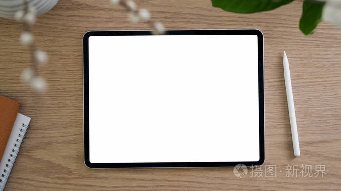 Top view of simple workspace with blank screen tablet, stylus an