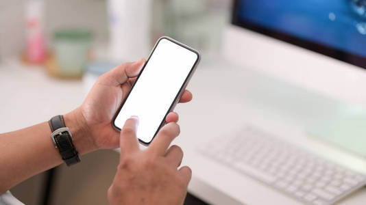 Closeup view of businessman using blank screen smartphone 