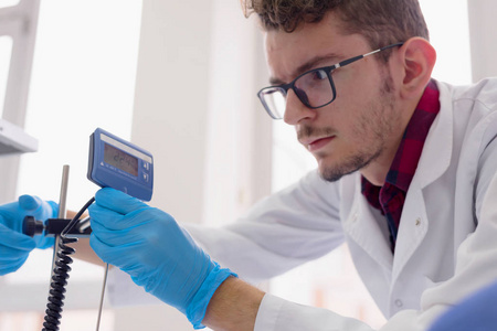 Young male scientist  doing research, microbiological analysis, 