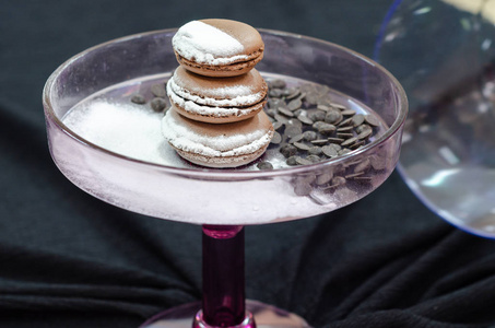 French macarons with powdered sugar, and chocolate, Closeup 