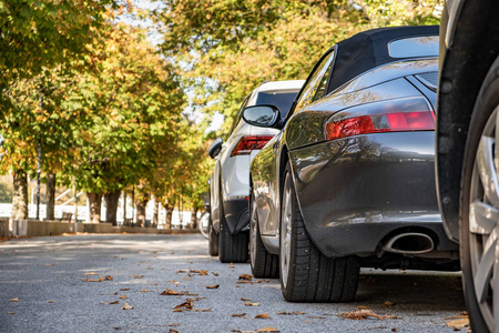 Modern cars parked on city street side in residential discrict. 