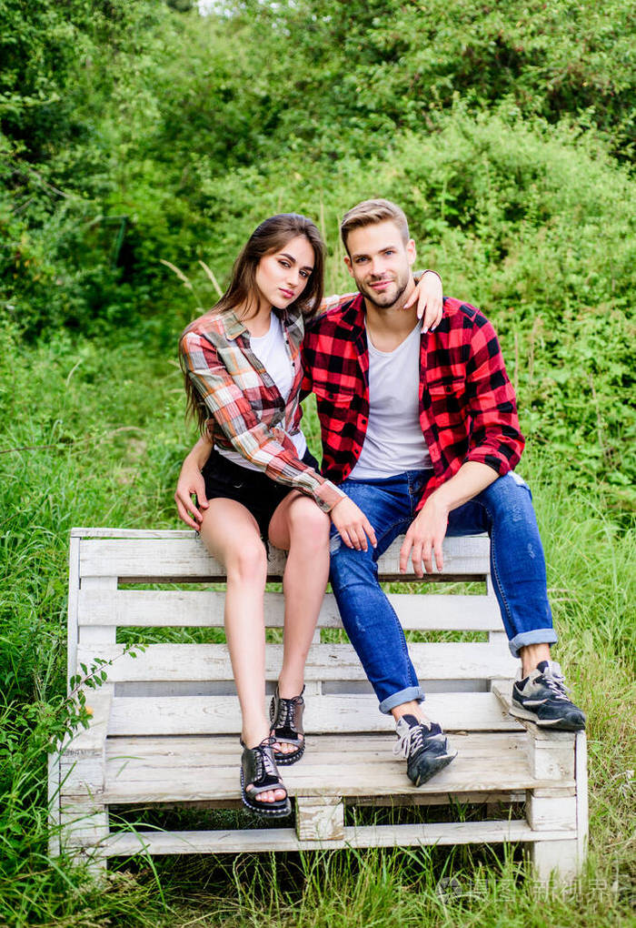恋爱中相爱的情侣方格时尚夫妇俩在户外长凳上放松关系家庭农场周末
