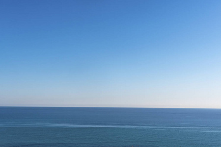 Clear sky and calm sea or ocean water surface 