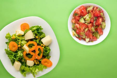  salad of cheese, lettuce, corn, pepper on a colored  background