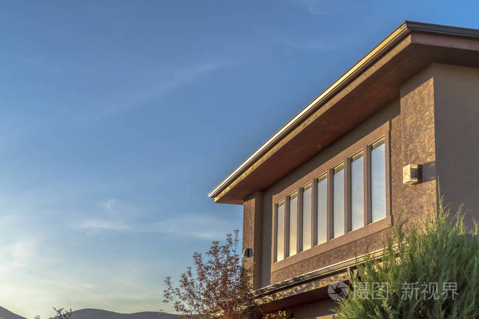 阳光明媚的房子外部在山和天空的映衬下可以看到楼上的景色