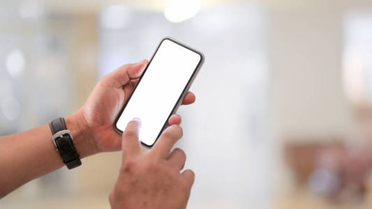 Closeup view of businessman using blank screen smartphone 