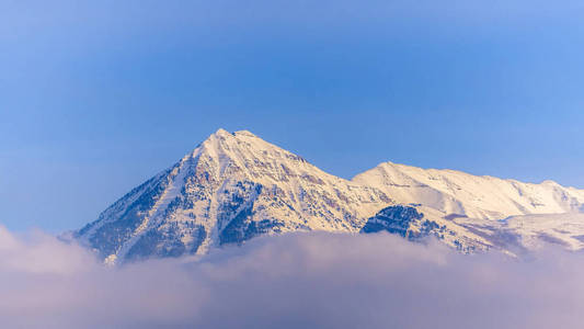 图为冬季背景为蓝天的Timpanogos山被白雪覆盖的全景画面