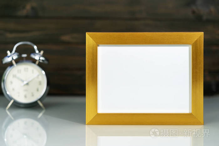 Mockup with golden frame and alarm clock 