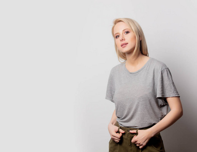 Beautiful blonde woman in brown tshirt on white background 