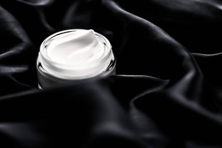 Luxury sensitive skincare moisturizing face cream on black silk 