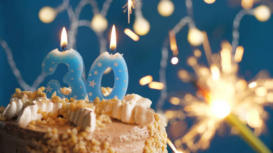 生日蛋糕上有30支蜡烛和燃烧的火花。特写