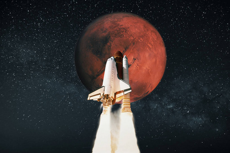 宇宙飞船在火星上发射.太空火箭飞向星空中的行星.旅游概念照片