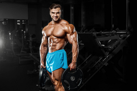 good looking fitness man pumping up muscles 