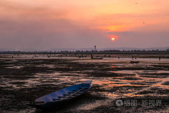 sunrise with arid land and fishing boat 