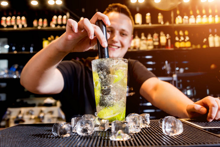 Bartender is making cocktail at bar counter. Fresh cocktails. 