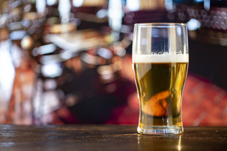 Glass of fresh beer at the bar. 