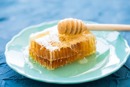 蜂蜜用木制的蜂蜜勺和蜂巢图片