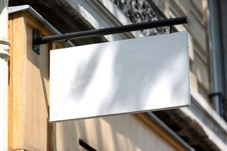 Blank sign board on a shop wall 