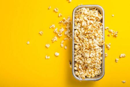 Popcorn viewed from above on yellow background. Flat lay  bowl. 