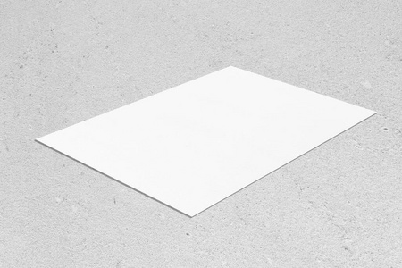 空的白色矩形海报模型斜躺在中性灰色混凝土背景上