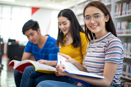 Group Asian  Students Smile and reading book and using notebook 