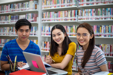 Group Asian  Students Smile and reading book and using notebook 