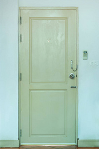 Wooden Door with Light Switch and Air Conditioner Remote in the 