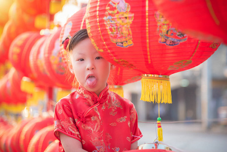 Little asian girl wearing chinese treditional costume standing w