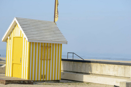 Yellow striped hut next to the Esmoriz beach in Portugar 